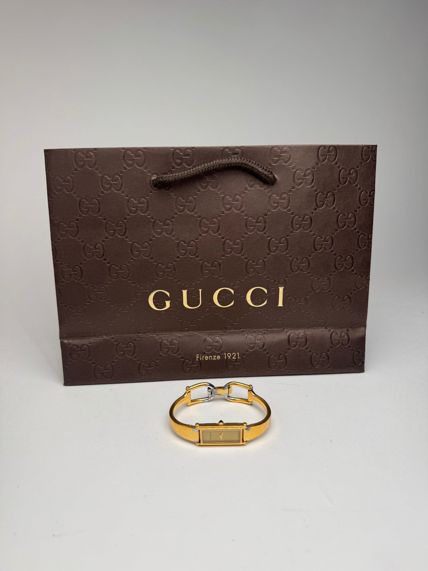 Montre Gucci vintage en acier et or avec mors