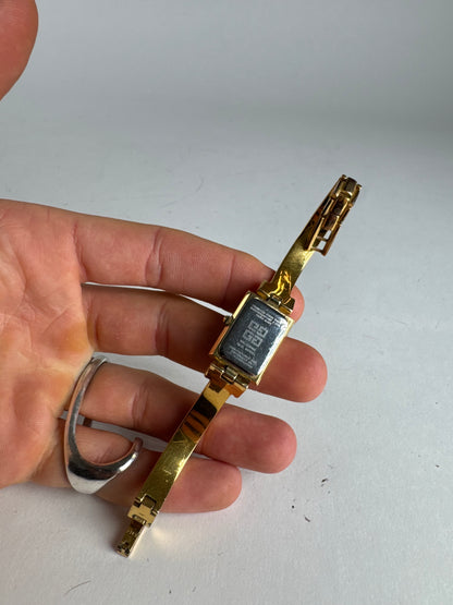 Montre vintage Givenchy en acier à quartz doré Millesime