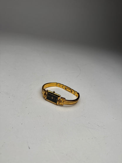 Montre vintage Givenchy en acier à quartz doré Millesime