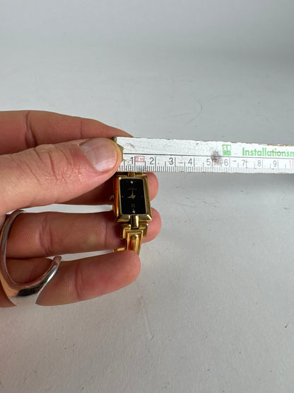 Montre vintage Givenchy en acier à quartz doré Millesime