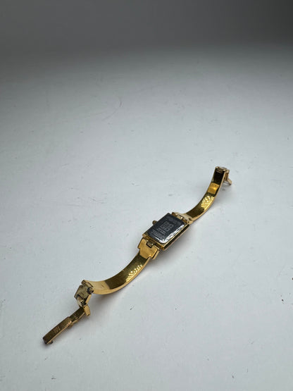 Montre vintage Givenchy en acier à quartz doré Millesime