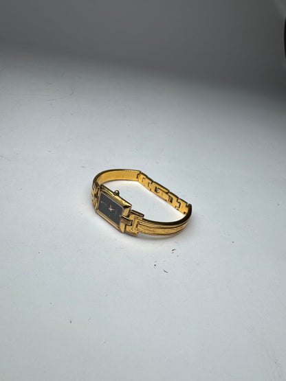 Montre vintage Givenchy en acier à quartz doré Millesime