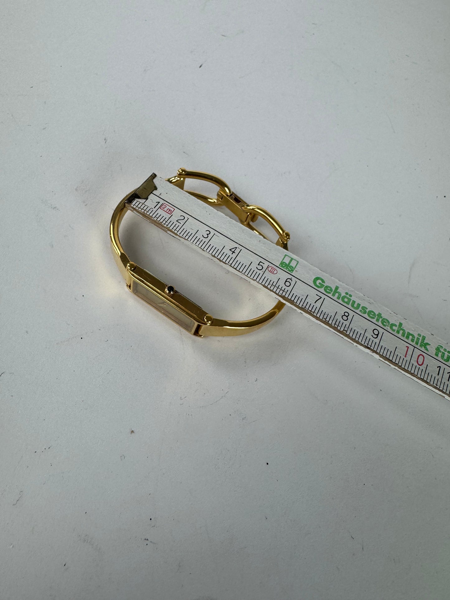 Montre Gucci vintage en acier avec mors de cheval doré