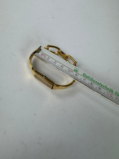 Montre Gucci vintage en acier avec mors de cheval doré