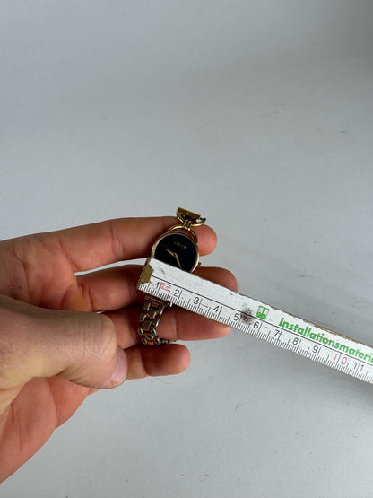 Montre Gucci vintage à quartz en acier avec mors doré