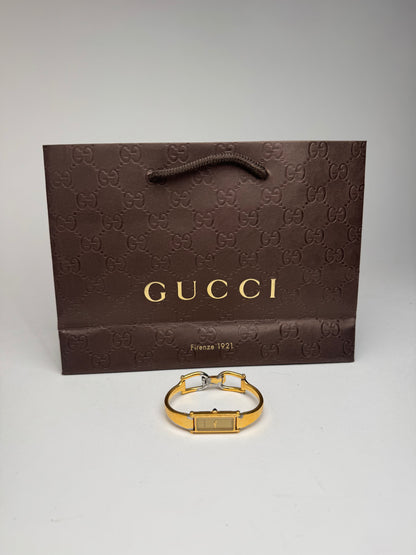 Montre Gucci vintage en acier et or avec mors