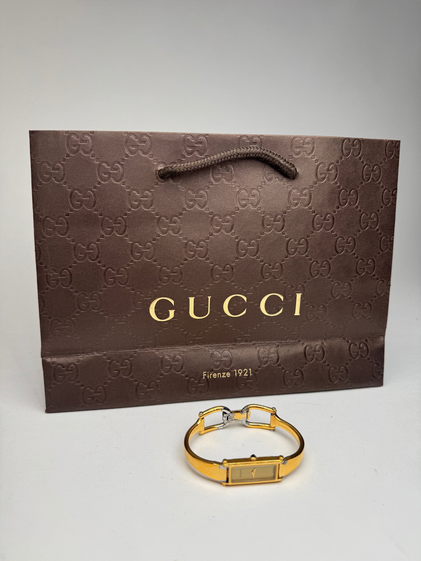 Montre Gucci vintage en acier et or avec mors