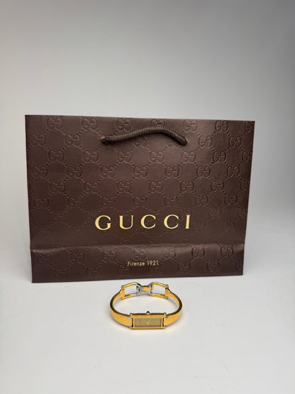 Montre Gucci vintage en acier et or avec mors