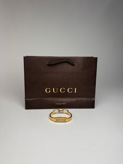 Montre Gucci vintage en acier et or avec mors
