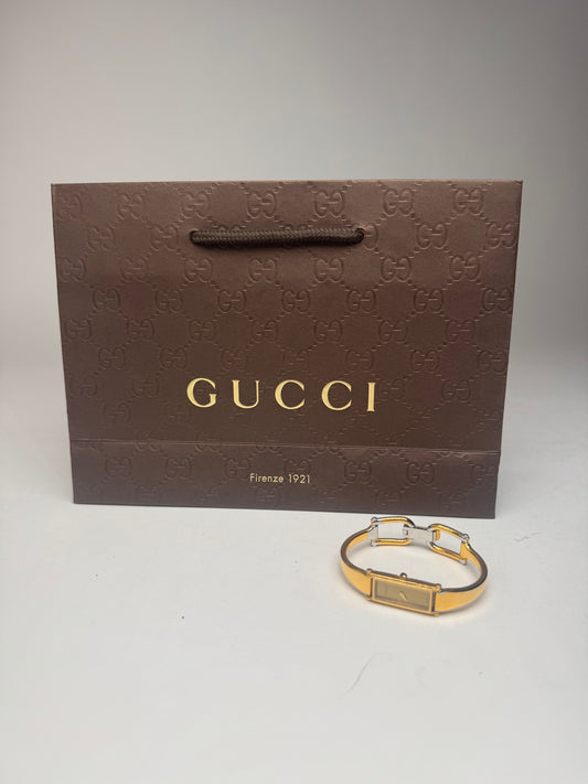 Montre Gucci vintage en acier et or avec mors