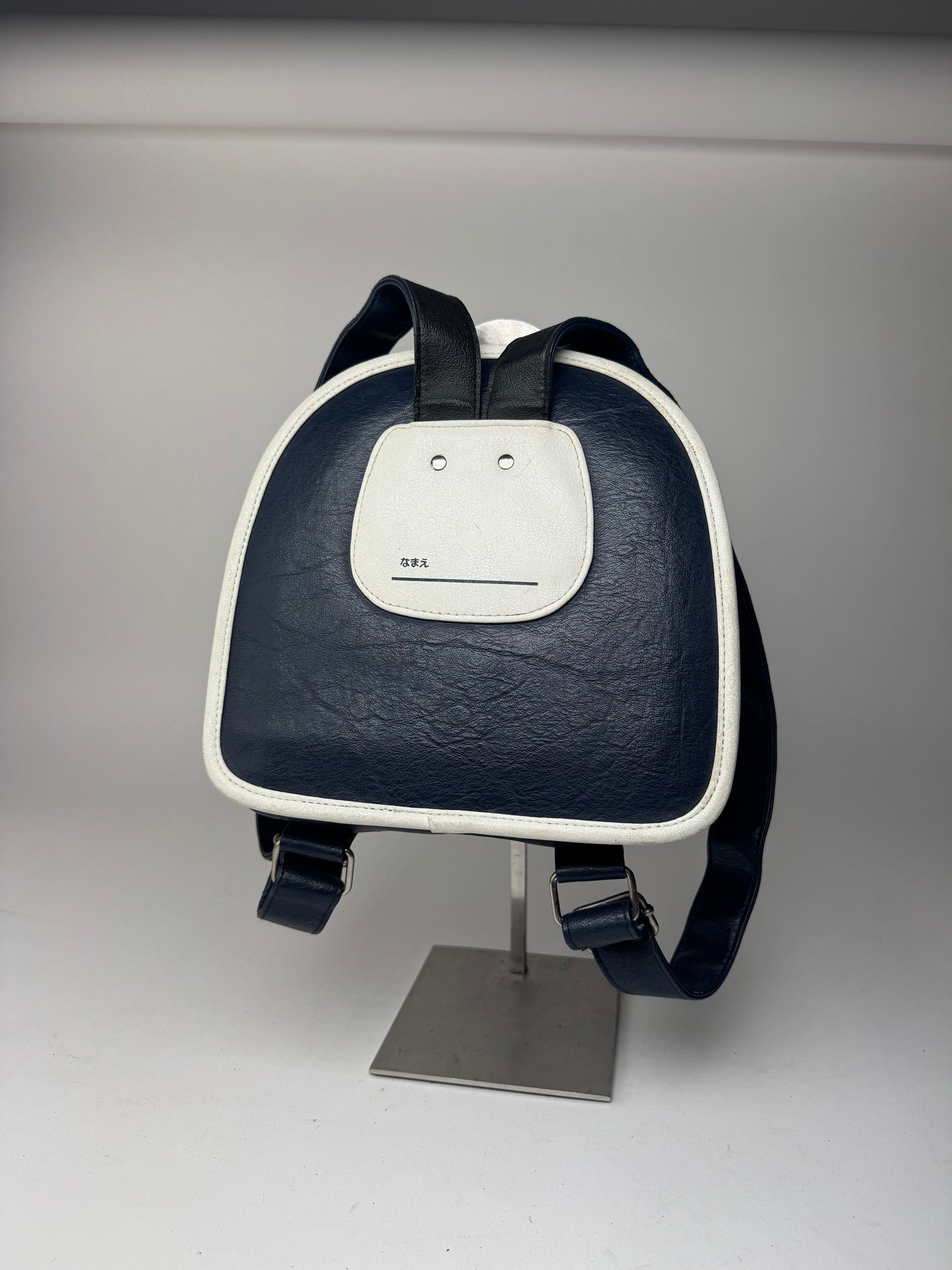 Sac à dos vintage Courreges Paris en cuir bleu marine et blanc