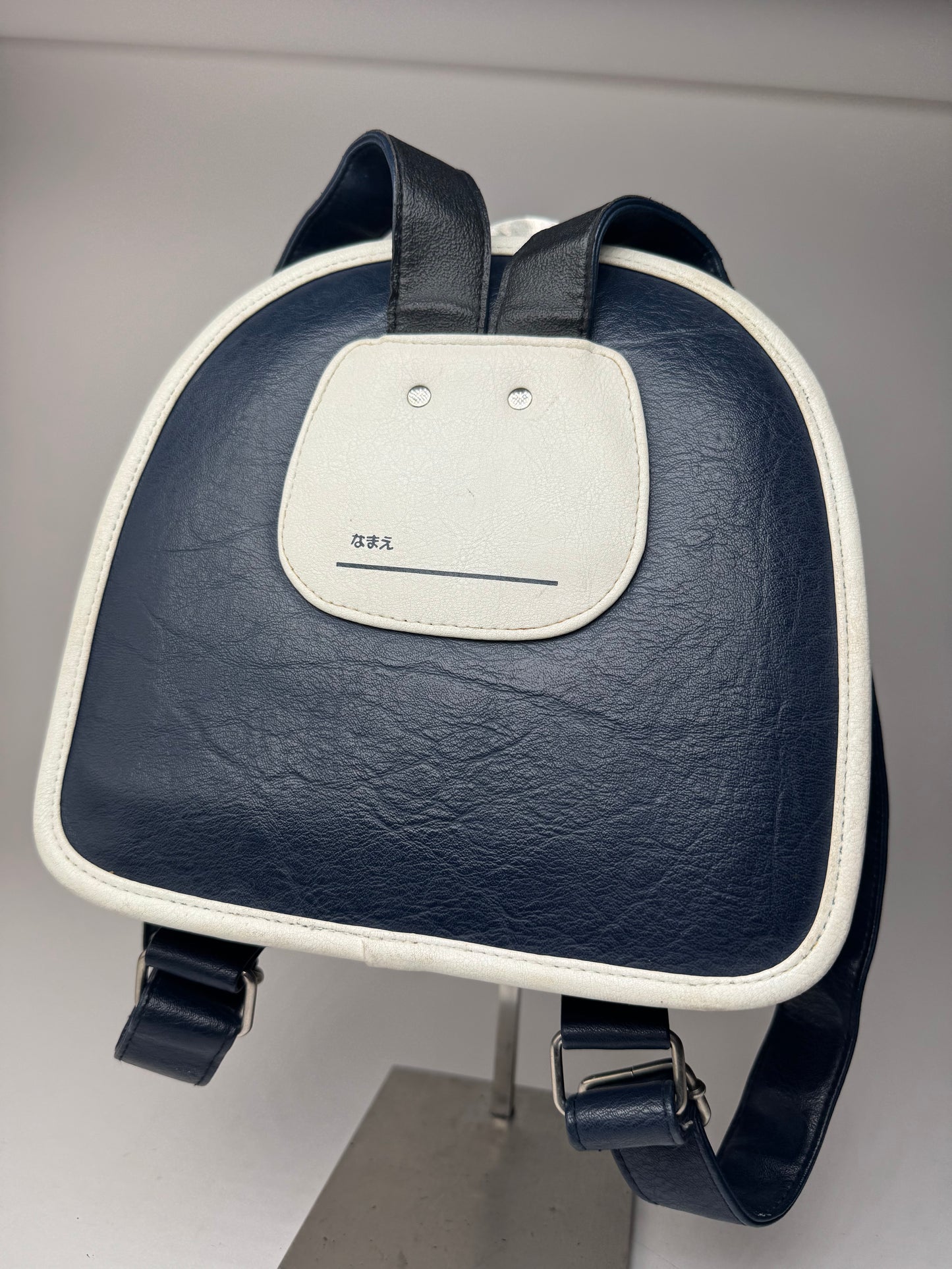 Sac à dos vintage Courreges Paris en cuir bleu marine et blanc