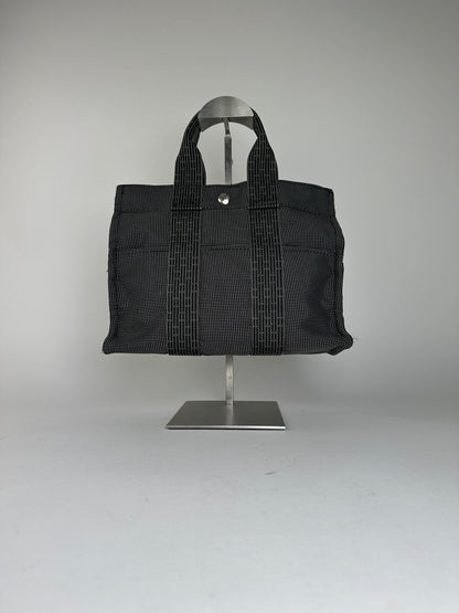 Hermès Black Canvas Tote Bag with Zip Closure and Snap Button